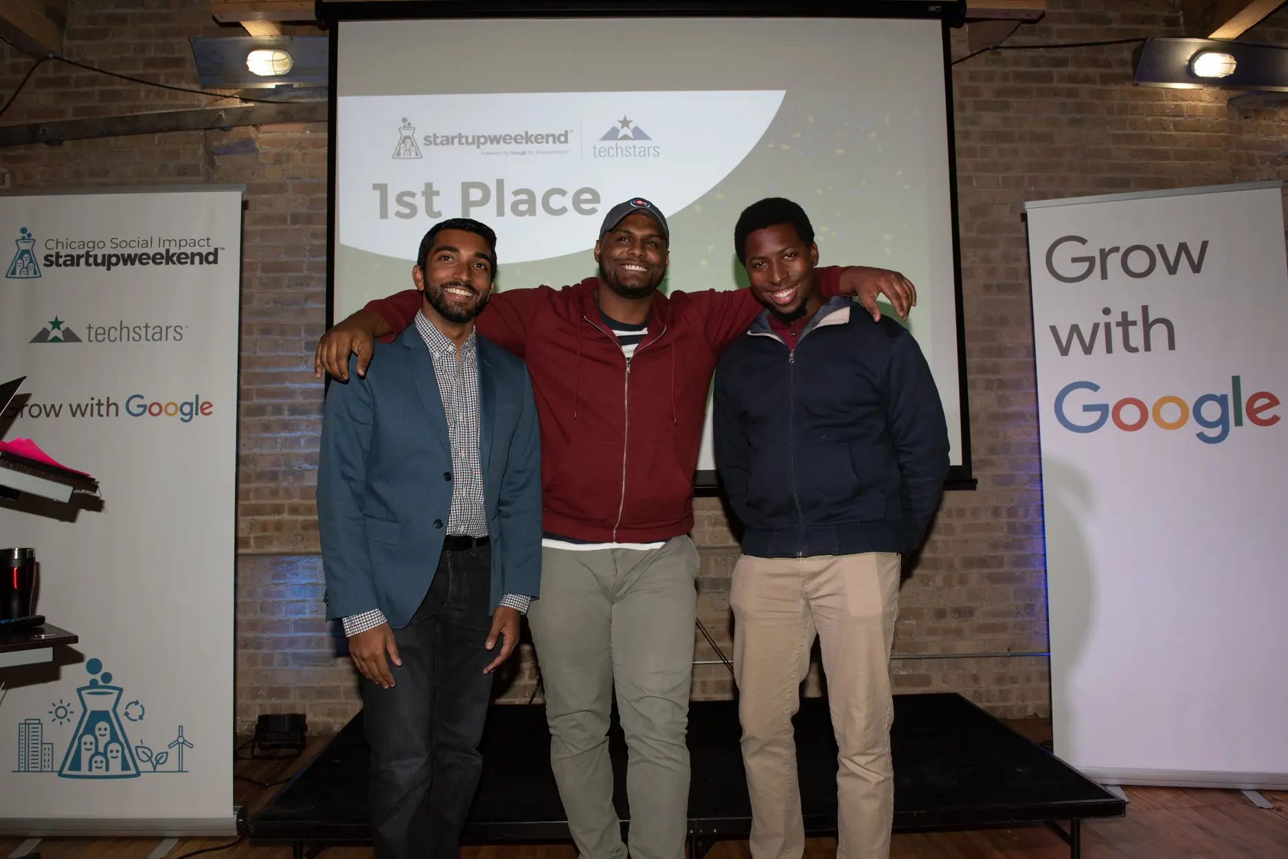 A photo of Bejoy and two others, standing for 1st place at a hackathon.